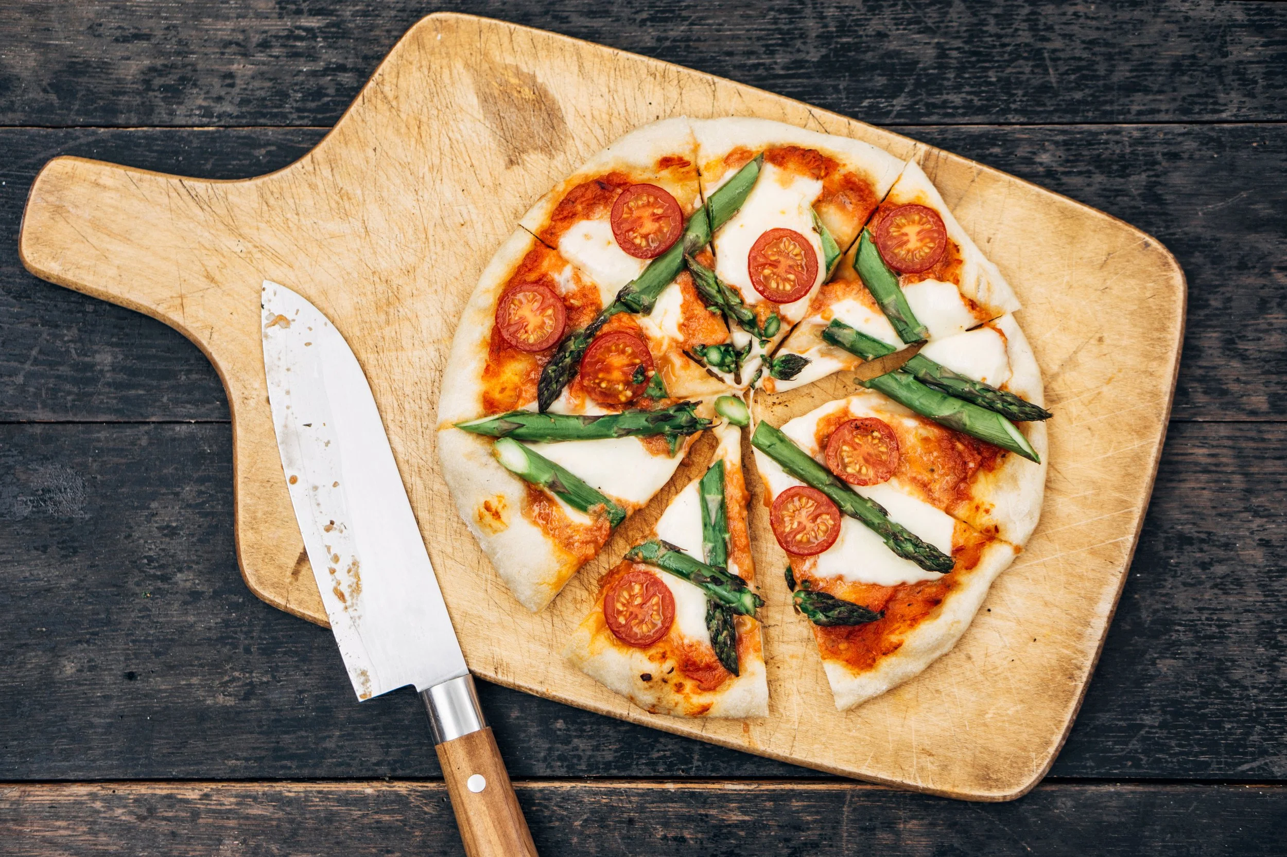 Fresh pizza on a wooden board